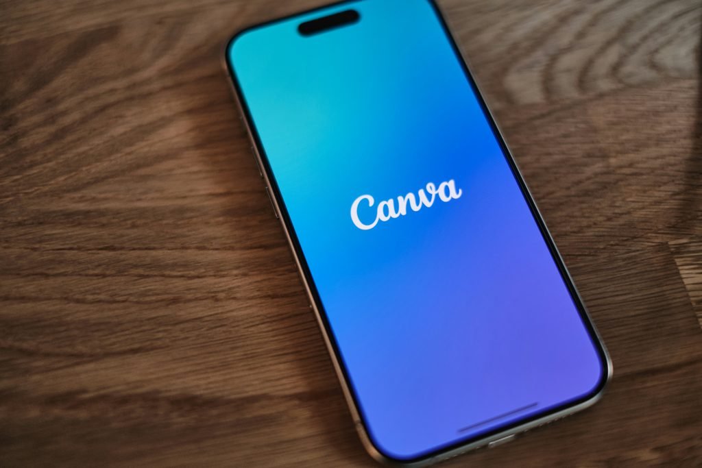 a phone on table with the canva app on sreen