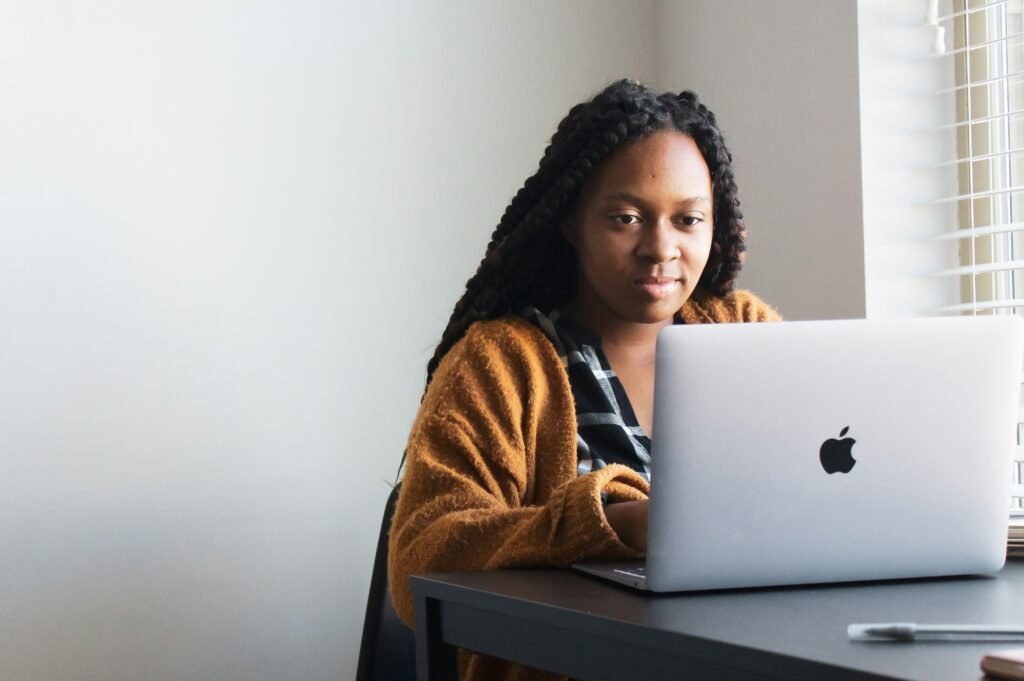 woman sitting by a laptop